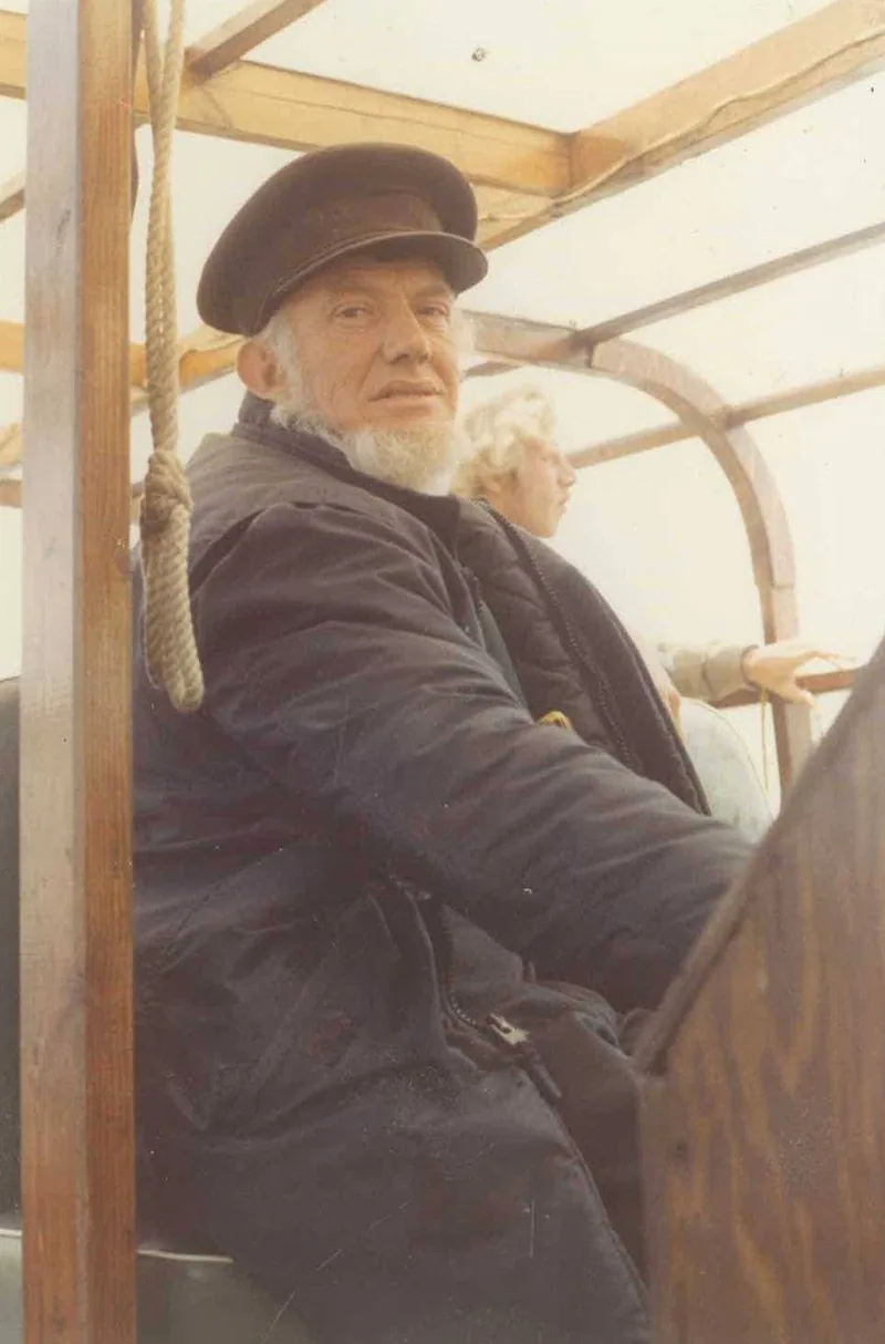 Captain Joe sitting at the captain's seat on the Eastwind III in 1986