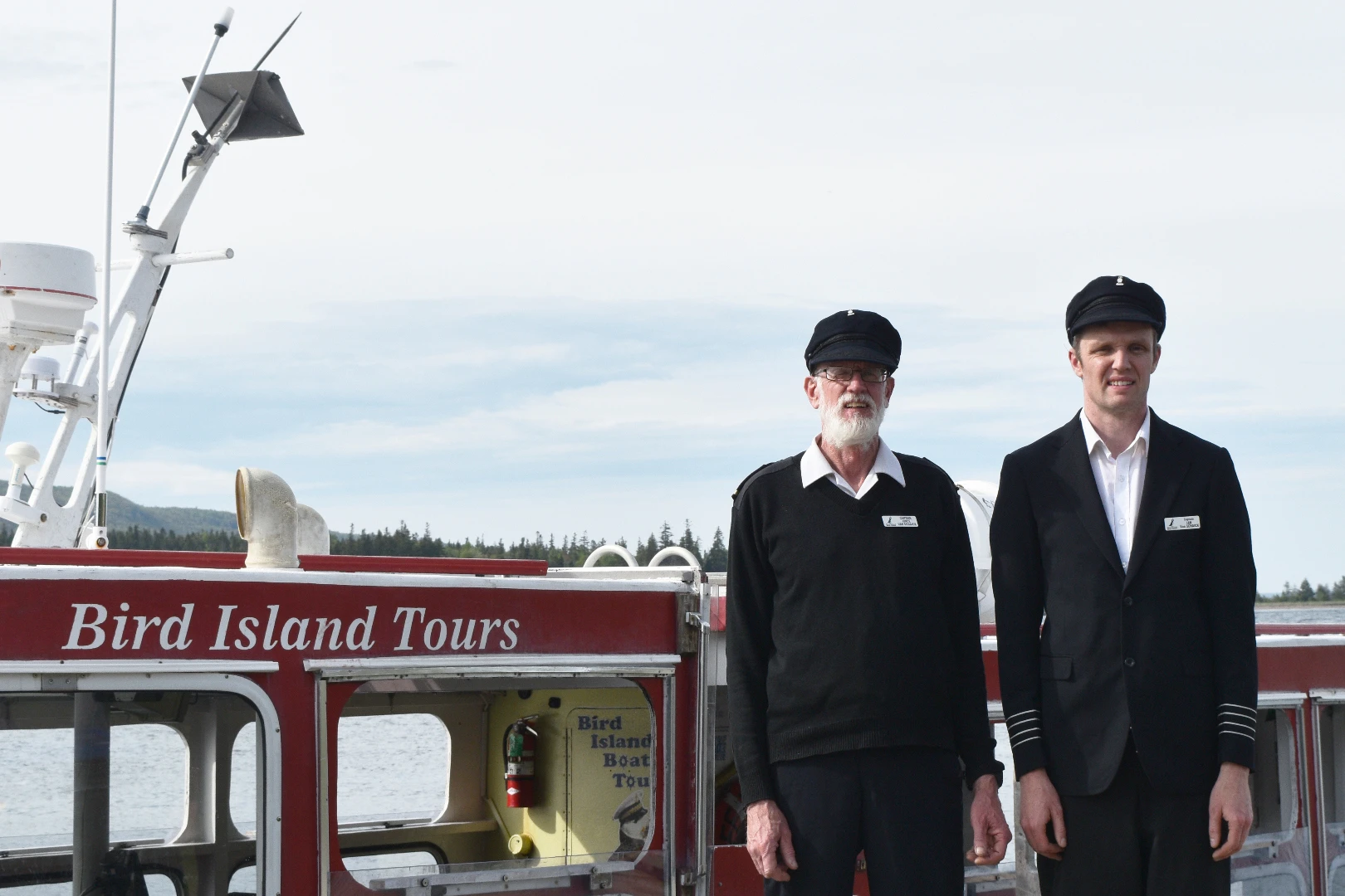 Captain Vince & Captain Ian standing in front of the Puffin Express boat in 2026
